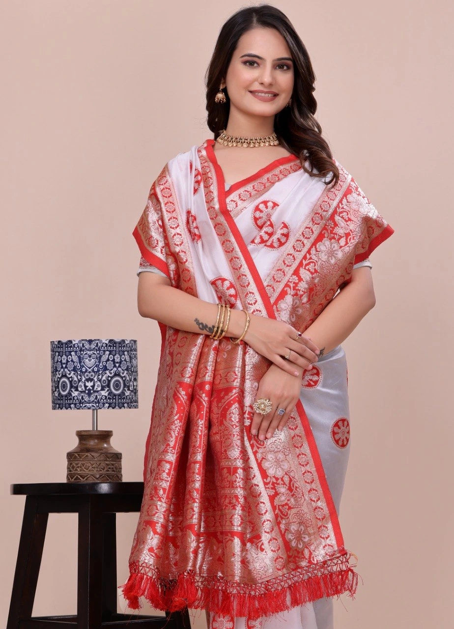 Woman wearing a red and white saree with a beige background